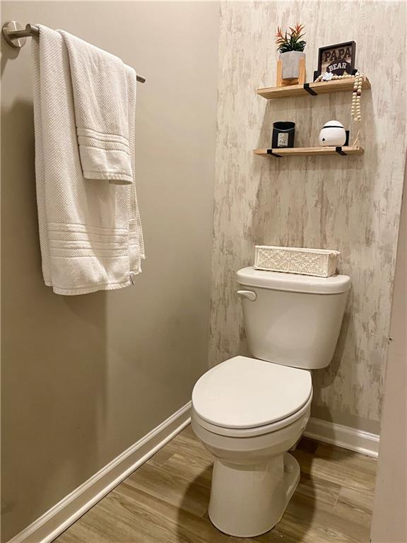 5149 Fox Den Road Oakwood, GA 30566 - Photo 33 of 44 a bathroom with a toilet and a shower curtain