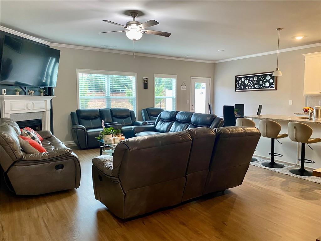 5149 Fox Den Road Oakwood, GA 30566 - Photo 5 of 44 a living room with furniture a fireplace and a flat screen tv