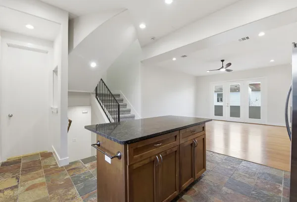 a kitchen with stainless steel appliances granite countertop a stove a sink and a refrigerator