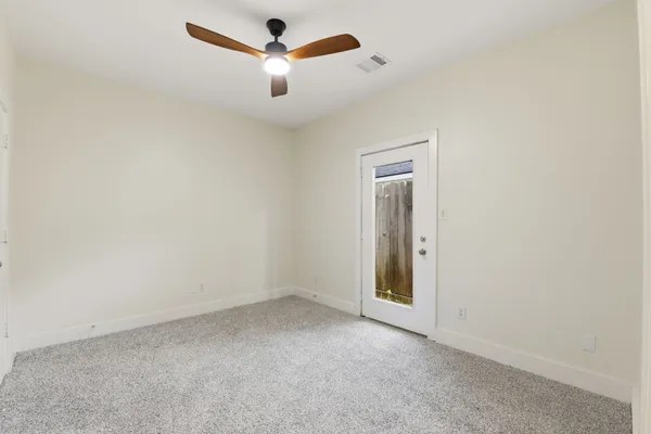 an empty room with a empty space and a ceiling fan