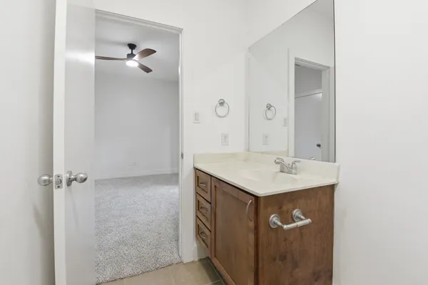 a bathroom with a sink mirror and vanity