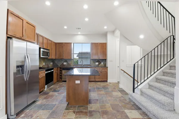 a large kitchen with stainless steel appliances lots of counter top space