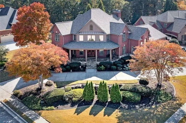 a view of a house with a yard and sitting area