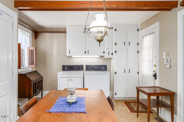a view of fireplace and wooden cabinets
