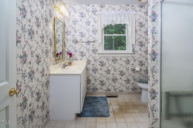 a bathroom with a glass shower door