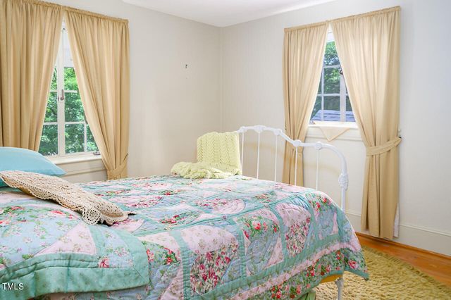 view of empty room with wooden floor and cabinet