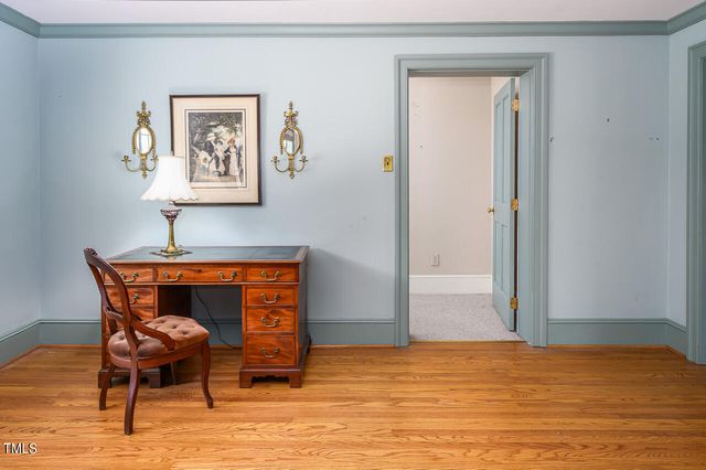 a view of a room with wooden floor and a window