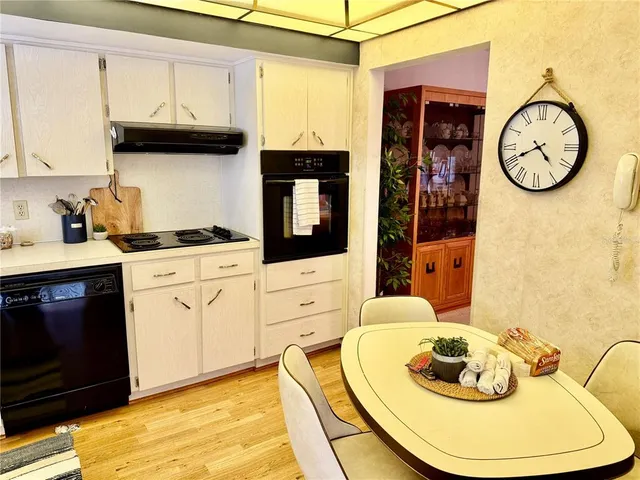 a kitchen with a appliances a stove and a dining table with painted walls