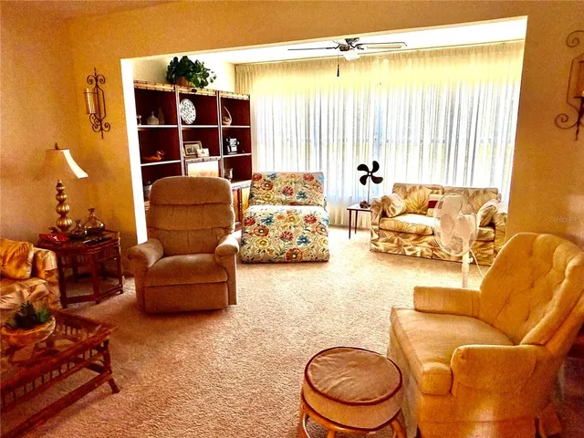 a living room with furniture a lamp and rug