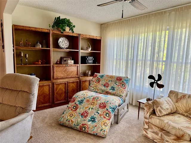 a bedroom with furniture and a book shelf