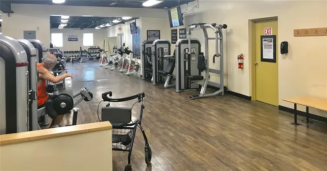 a room with gym equipment and a view of living room