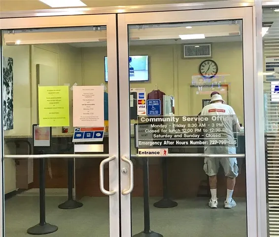 a room with stainless steel appliances and chandelier
