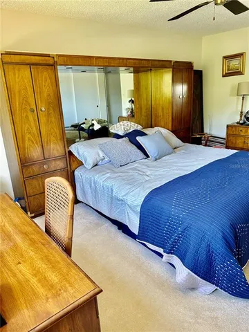 a bedroom with a bed and chair