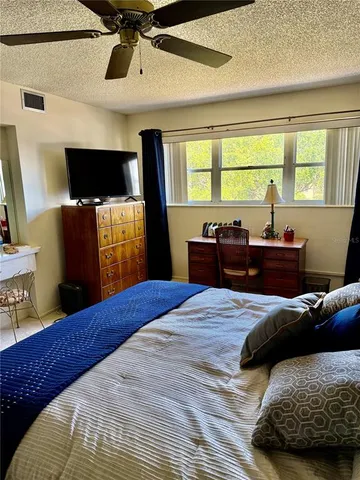 a bedroom with a bed and a television