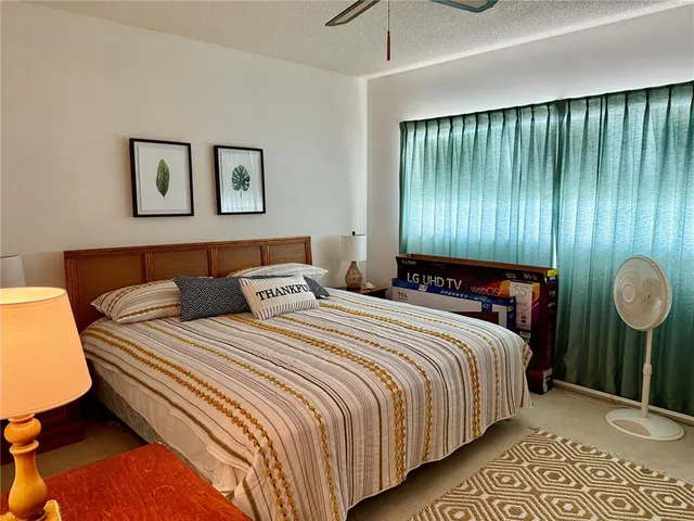 a bedroom with bed and window