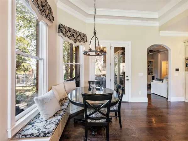 a living room with furniture a fireplace and a chandelier