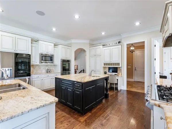 a living room with furniture and view of kitchen