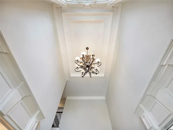 a view of a dining room with furniture a chandelier and wooden floor