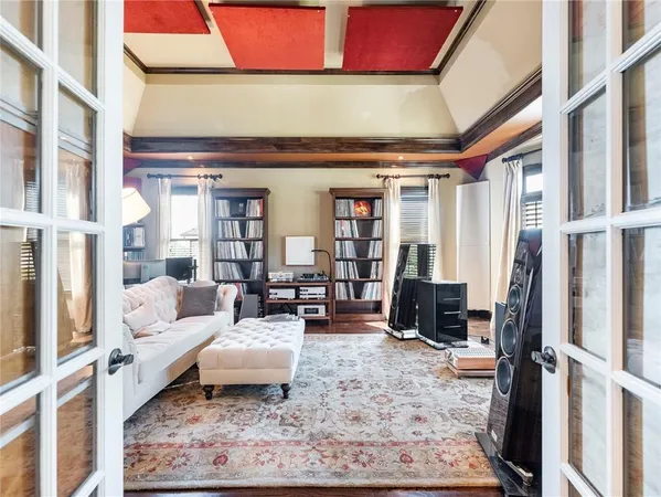 a living room with a bookshelf and a large window