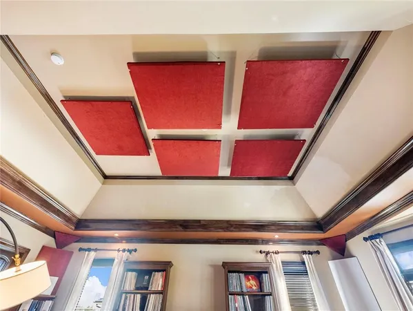 a spacious bedroom with a bed and a chandelier