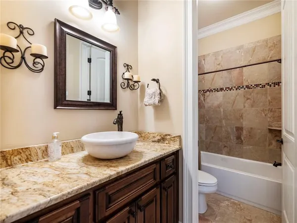 a bedroom with a bed and dresser with mirror