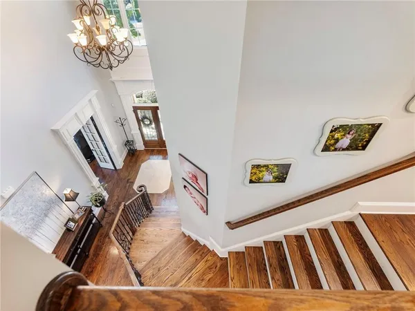 a spacious bedroom with a bed and a chandelier