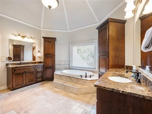 a view of a lake with table and chairs and floor to ceiling window