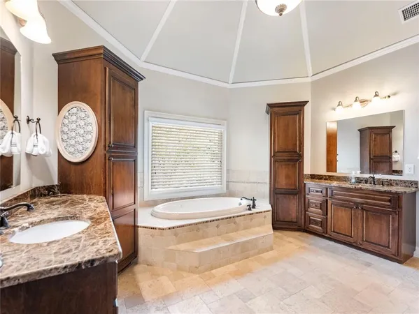 a front view of a house with a yard and large trees