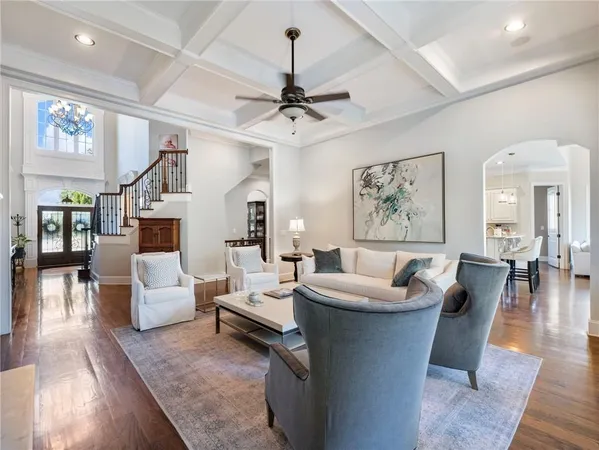 a kitchen with stainless steel appliances kitchen island granite countertop a dining table chairs stove refrigerator and cabinets