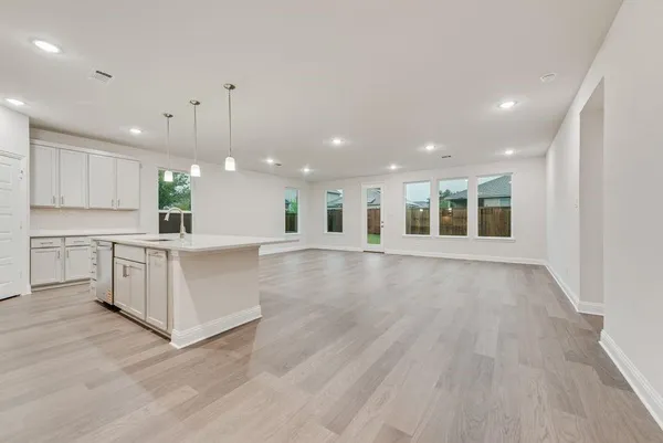 a view of kitchen with center island and wooden floor