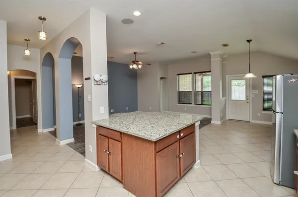 a kitchen with a counter top space and refrigerator