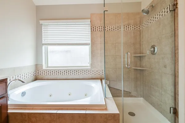 a bathroom with a tub and a shower