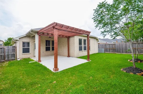 a view of a house with a yard and a garden
