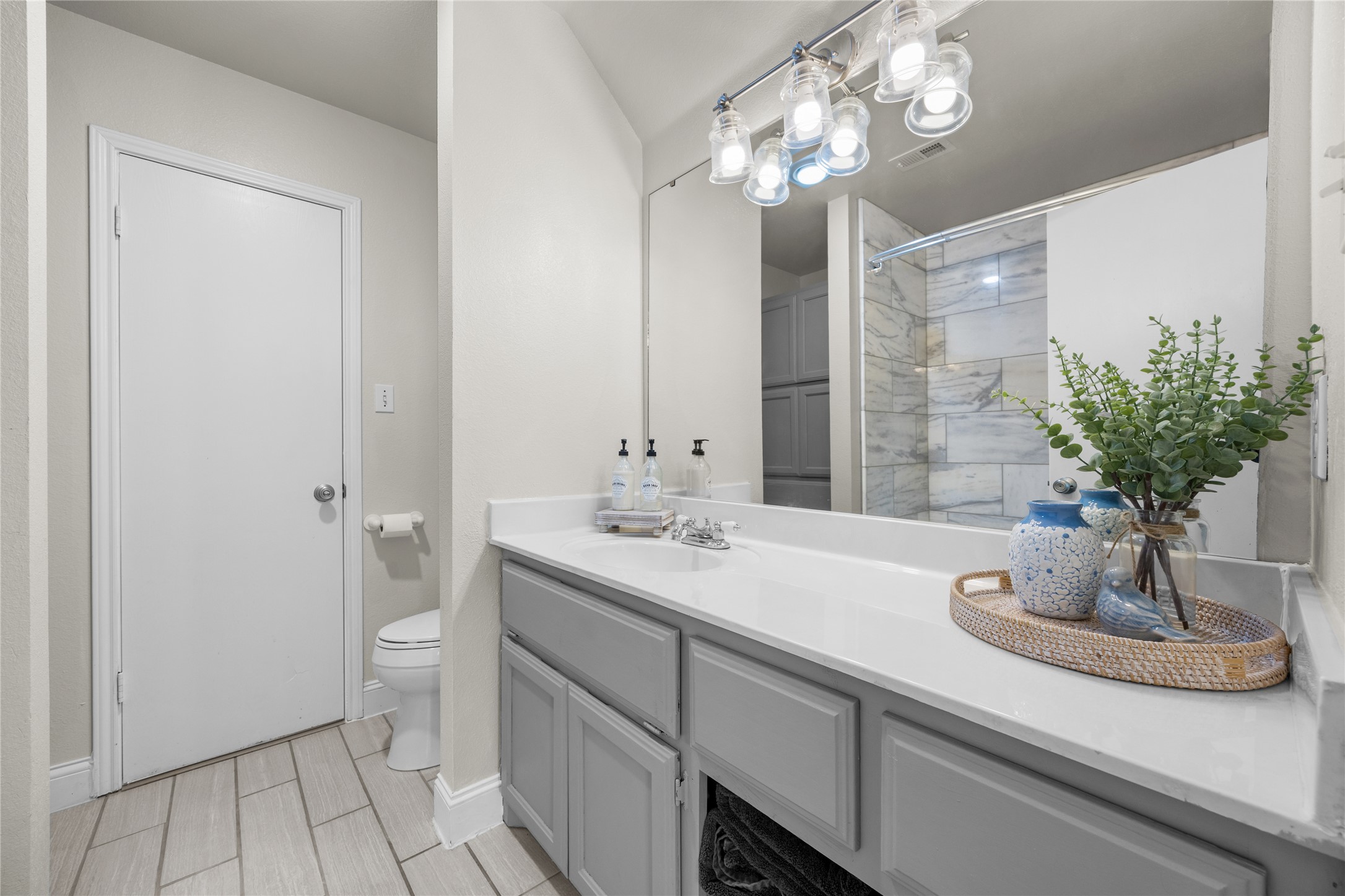 1283 Rattlesnake Trail Burnet, TX 78611 - Photo 27 of 39 a bathroom with a sink a large mirror and a shower
