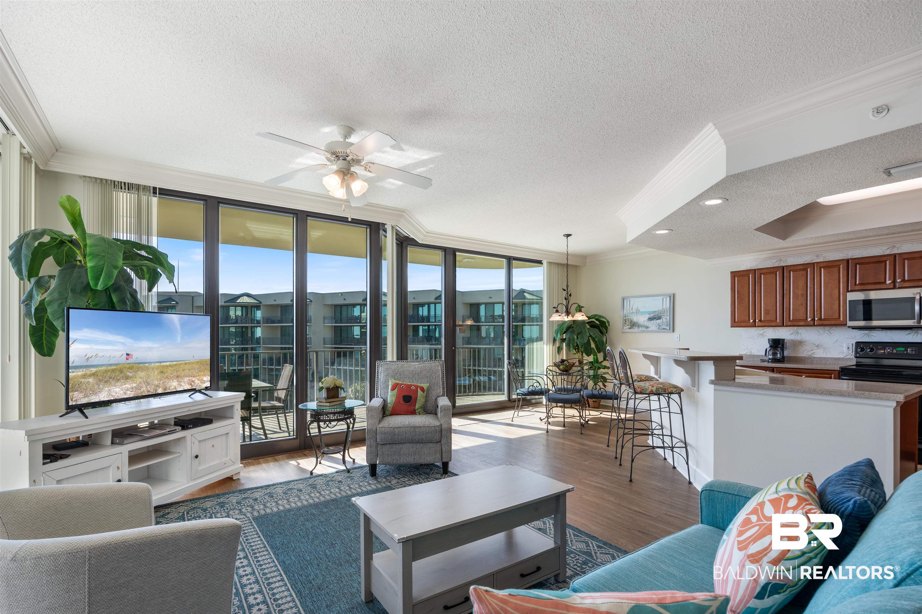 27580 Canal Road, Unit 1431 Orange Beach, AL 36561 - Photo 13 of 73 Living room with ornamental molding, a textured ceiling, wood finished floors, ceiling fan, and a wall of windows