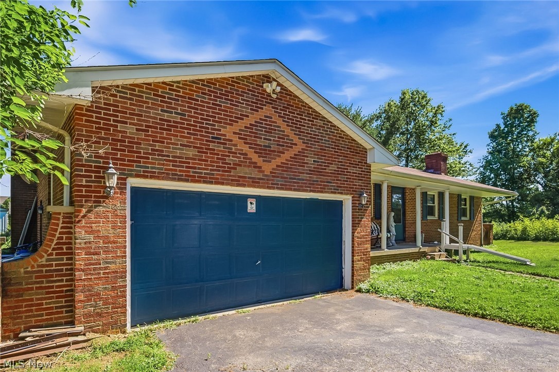 6890 Refugee Road Pickerington, OH 43147 - Photo 5 of 49 Brick exterior with a prominent blue garage door