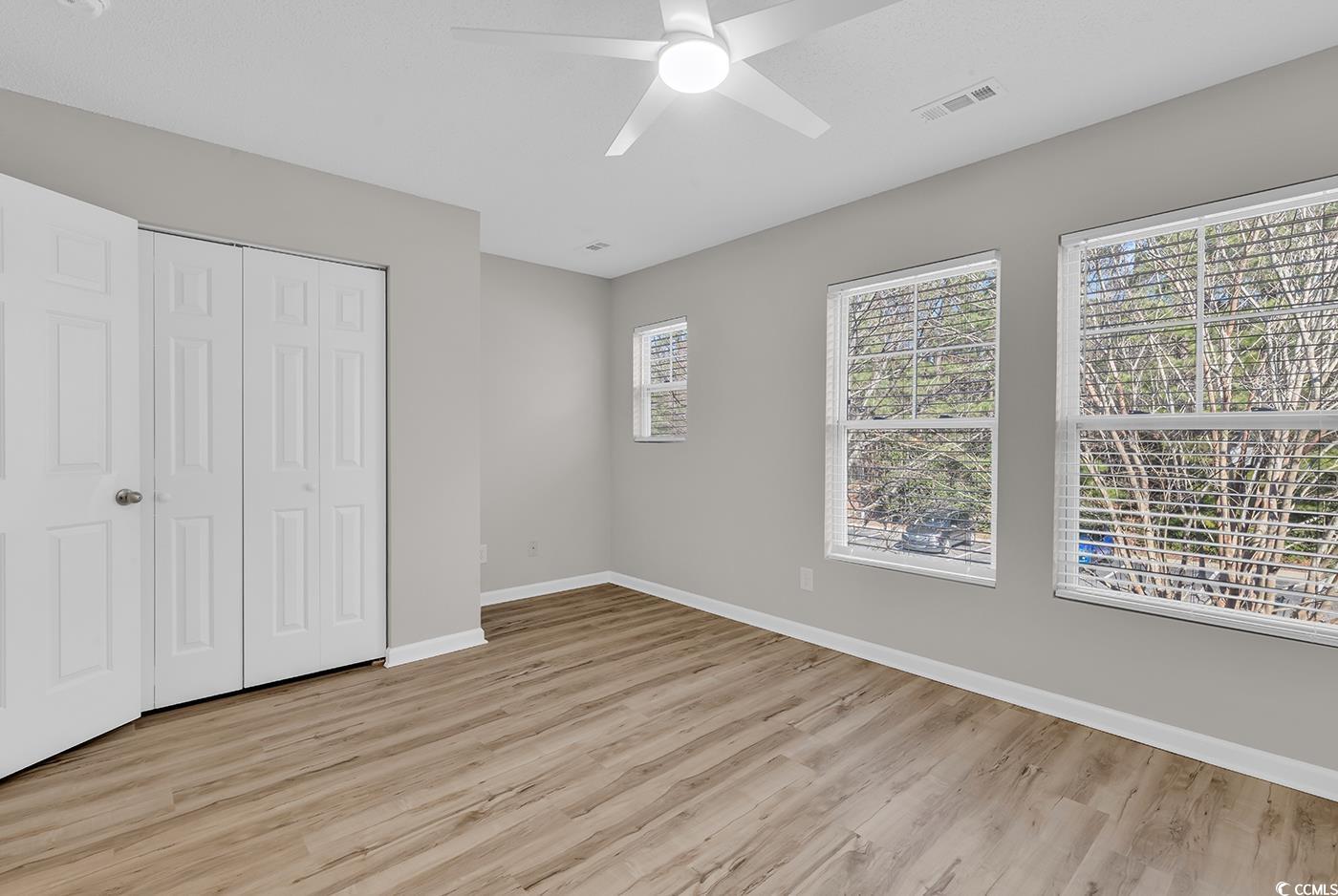308 Kiskadee Loop, Unit E Conway, SC 29526 - Photo 23 of 36 Unfurnished bedroom featuring light wood-type flooring, a closet, and ceiling fan
