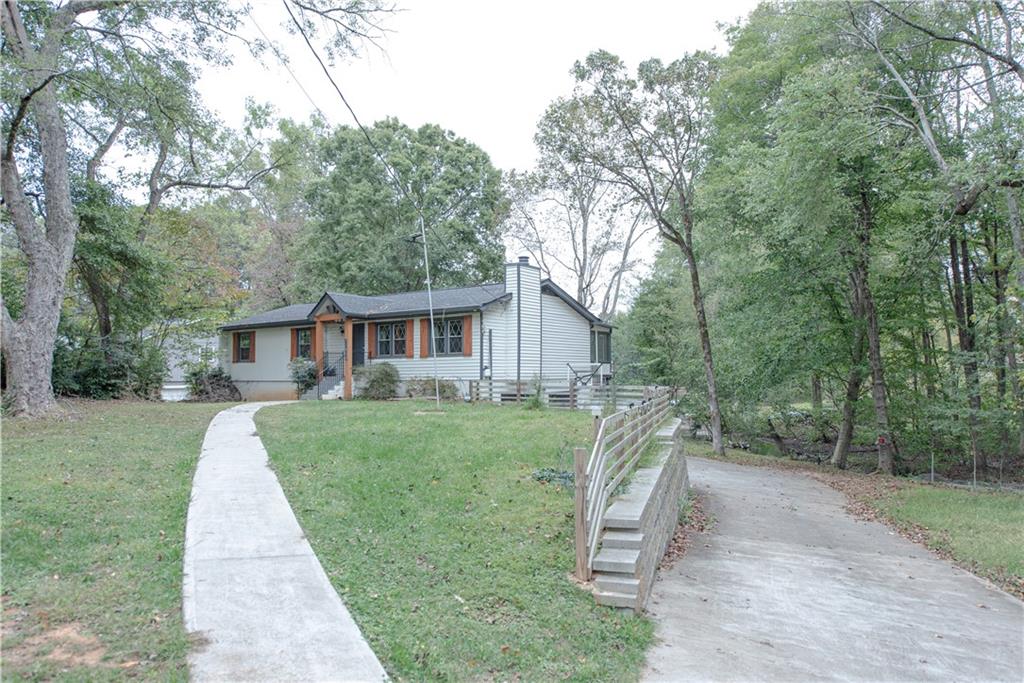 2702 Davenport Road Northwest Duluth, GA 30096 - Photo 2 of 32 a front view of a house with a yard and trees