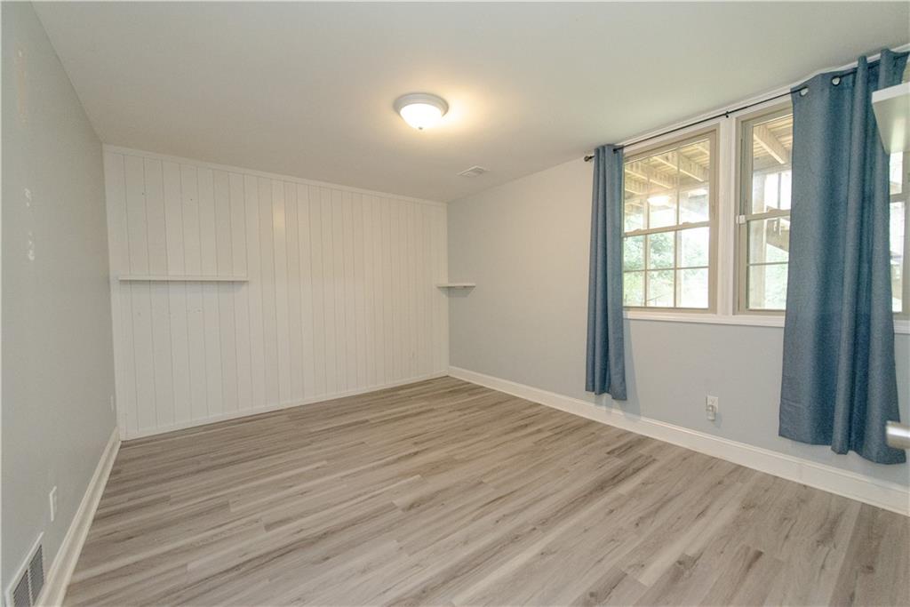 2702 Davenport Road Northwest Duluth, GA 30096 - Photo 29 of 32 a view of an empty room with wooden floor and a window