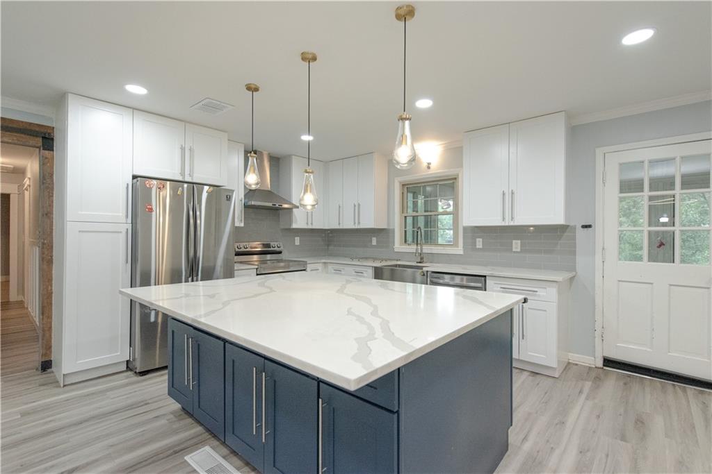 2702 Davenport Road Northwest Duluth, GA 30096 - Photo 9 of 32 a kitchen with stainless steel appliances granite countertop a refrigerator a sink and a stove