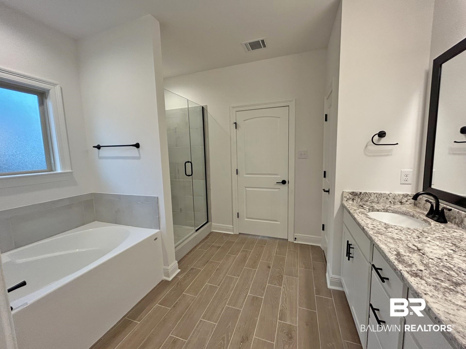 1744 Breckinridge Place Foley, AL 36535 - Photo 14 of 26 Full bathroom with vanity, wood finish floors, a bath, and a stall shower