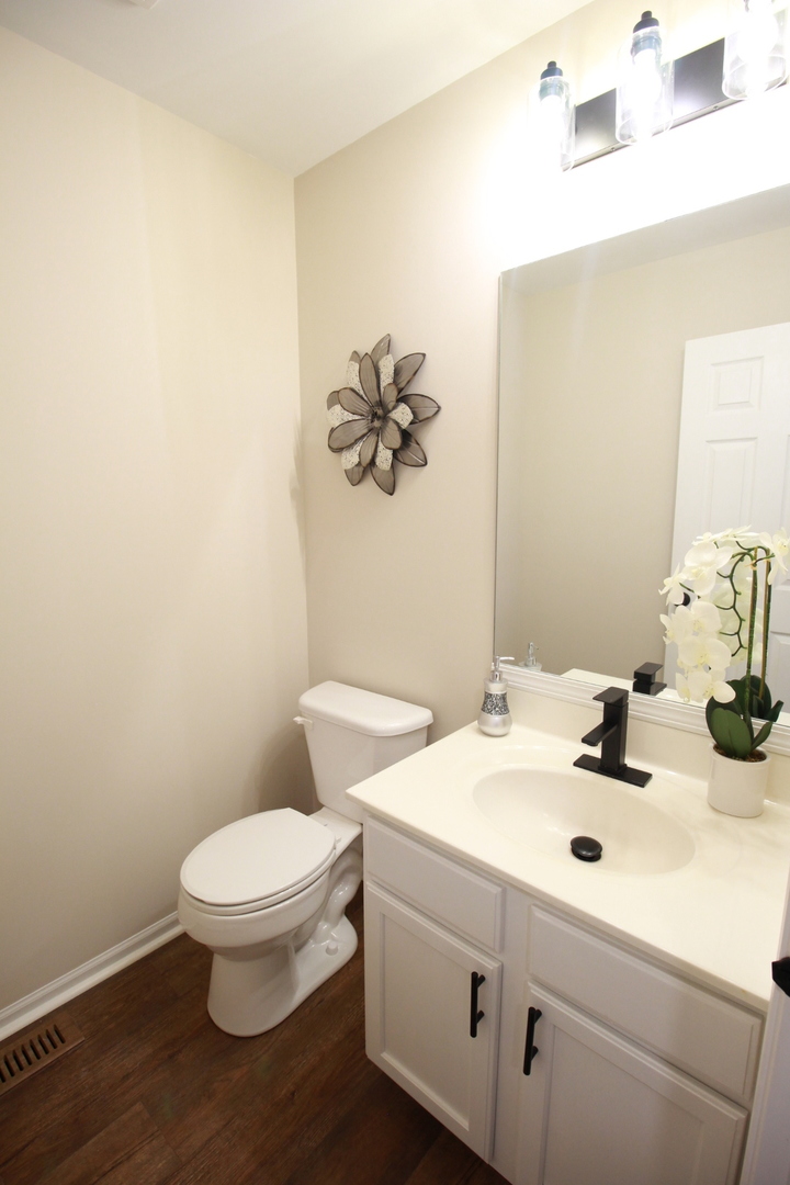 1947 Crestview Circle Romeoville, IL 60446 - Photo 14 of 28 a bathroom with a sink a toilet and mirror