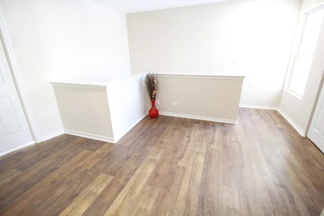 a view of a room with wooden floor and cabinet