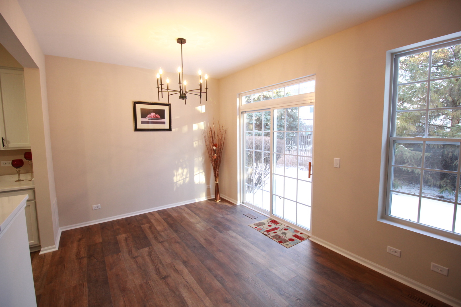 1947 Crestview Circle Romeoville, IL 60446 - Photo 9 of 28 a view of an empty room with wooden floor and a window