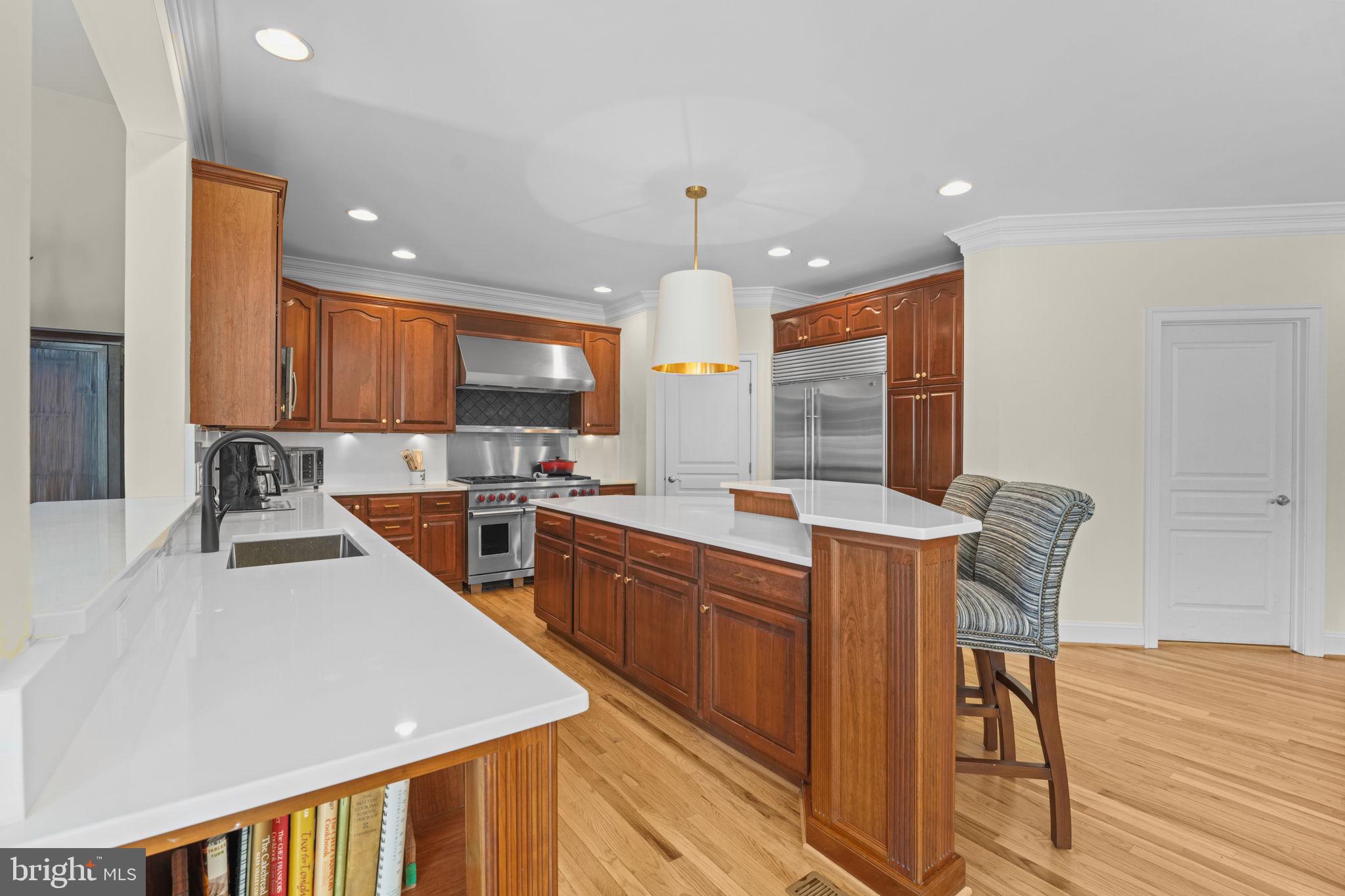 11431 Woolington Road Great Falls, VA 22066 - Photo 2 of 49 a large kitchen with stainless steel appliances kitchen island granite countertop a sink and cabinets
