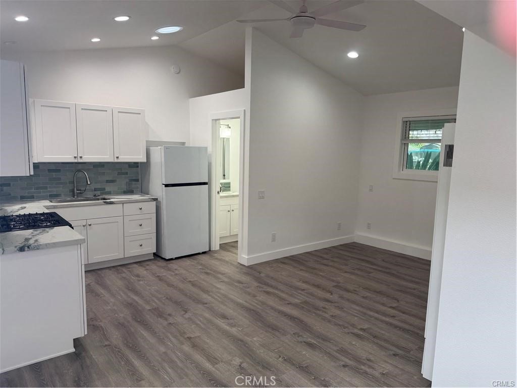 837 Santiago Road, Unit 1 Costa Mesa, CA 92626 - Photo 1 of 1 a kitchen with a refrigerator and a stove top oven
