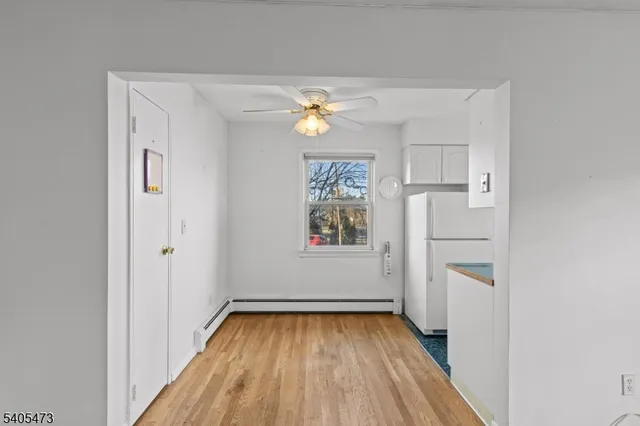 a view of empty room with closet and wooden floor