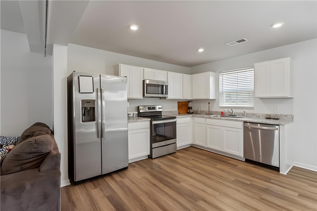 137 Nicklaus Drive Anderson, SC 29621 - Photo 6 of 37 A well-appointed culinary space featuring sleek stainless steel appliances and abundant white cabinetry.