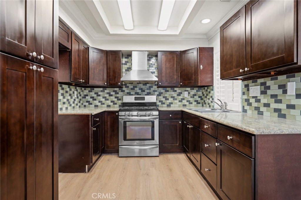 2405 Highland Pines Road Pomona, CA 91767 - Photo 15 of 32 a kitchen with stainless steel appliances kitchen island granite countertop a sink stove and refrigerator