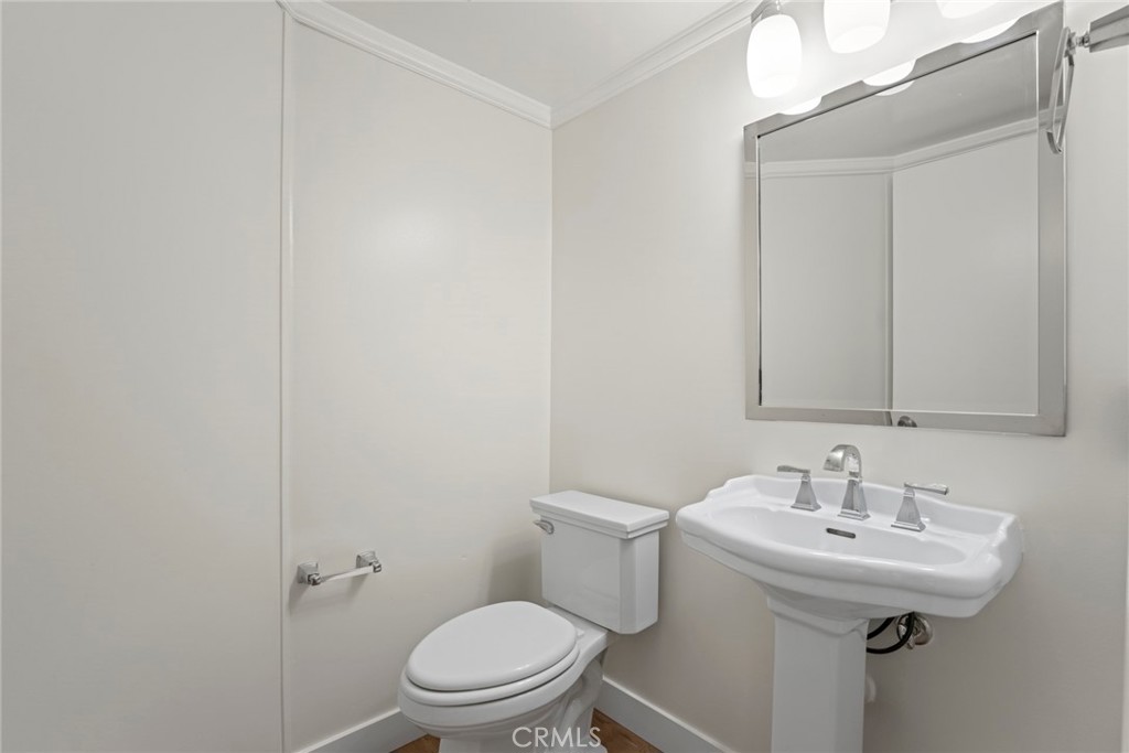 2405 Highland Pines Road Pomona, CA 91767 - Photo 17 of 32 a bathroom with a sink toilet and a mirror